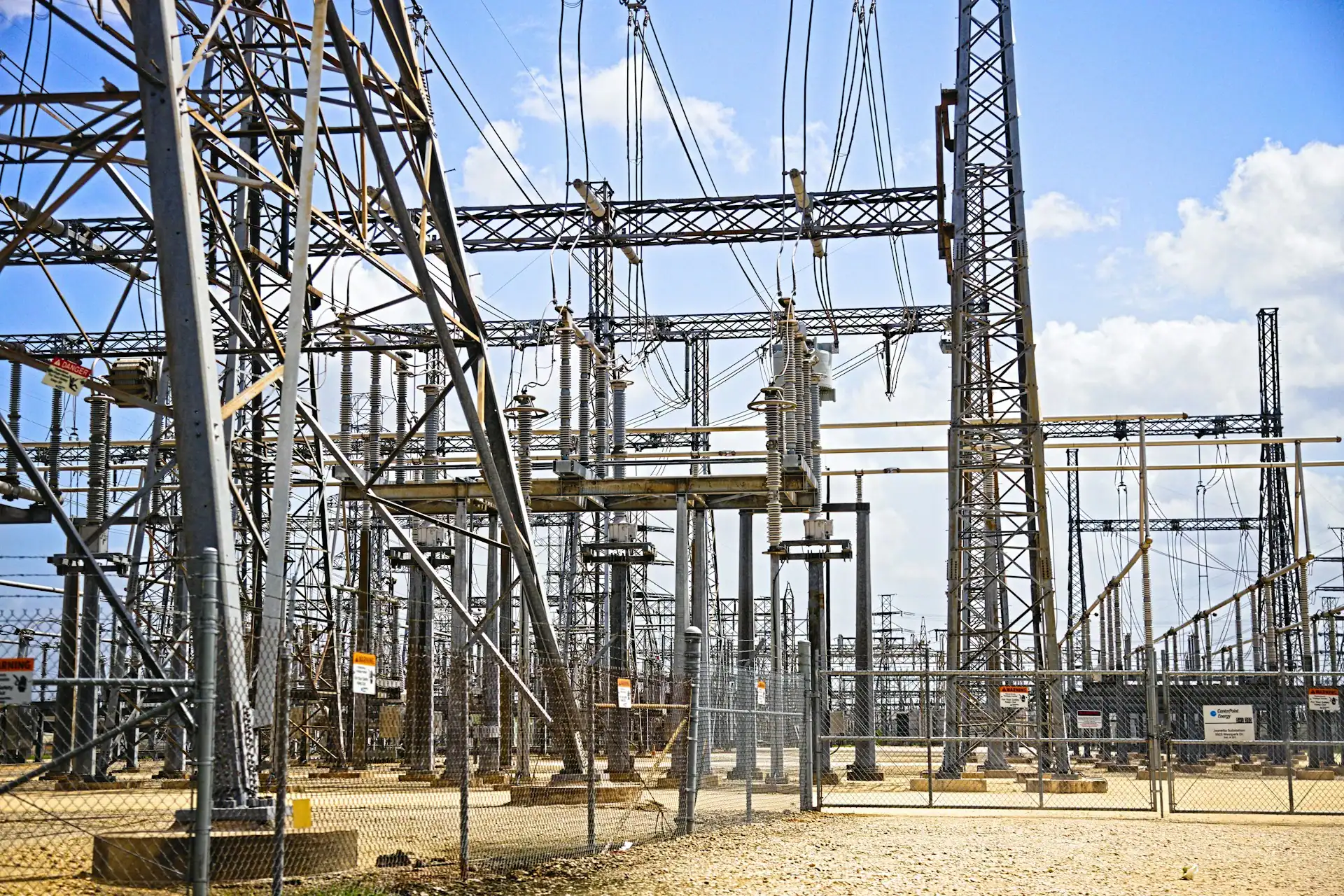 Umspannwerk mit Strommasten und elektrischer Infrastruktur unter blauem Himmel
